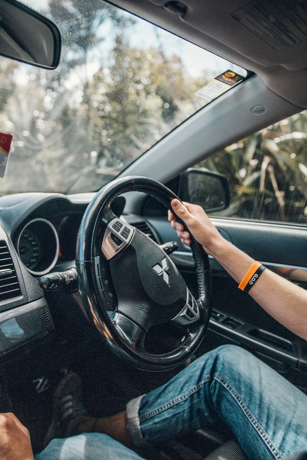 person holding black steering wheel