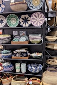 Close-up of colorful handmade woven baskets displayed on wooden shelves.
