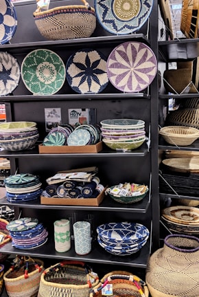 Close-up of colorful handmade woven baskets displayed on wooden shelves.