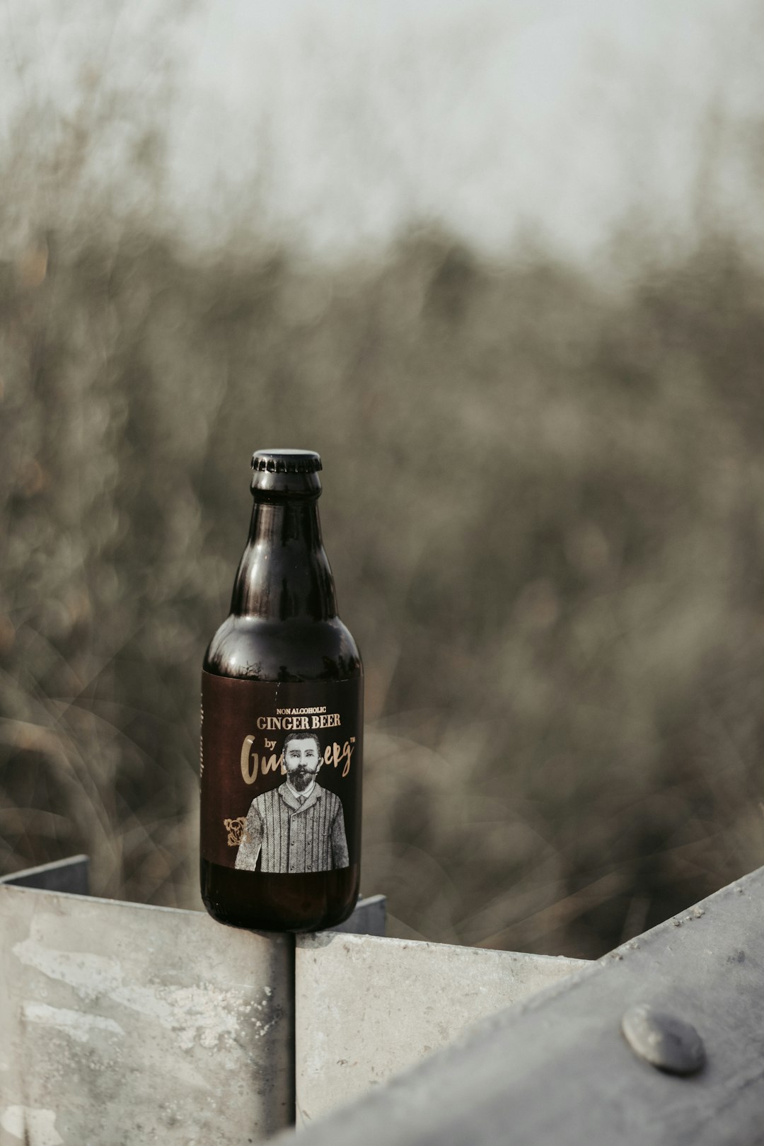 brown beer bottle on gray surface