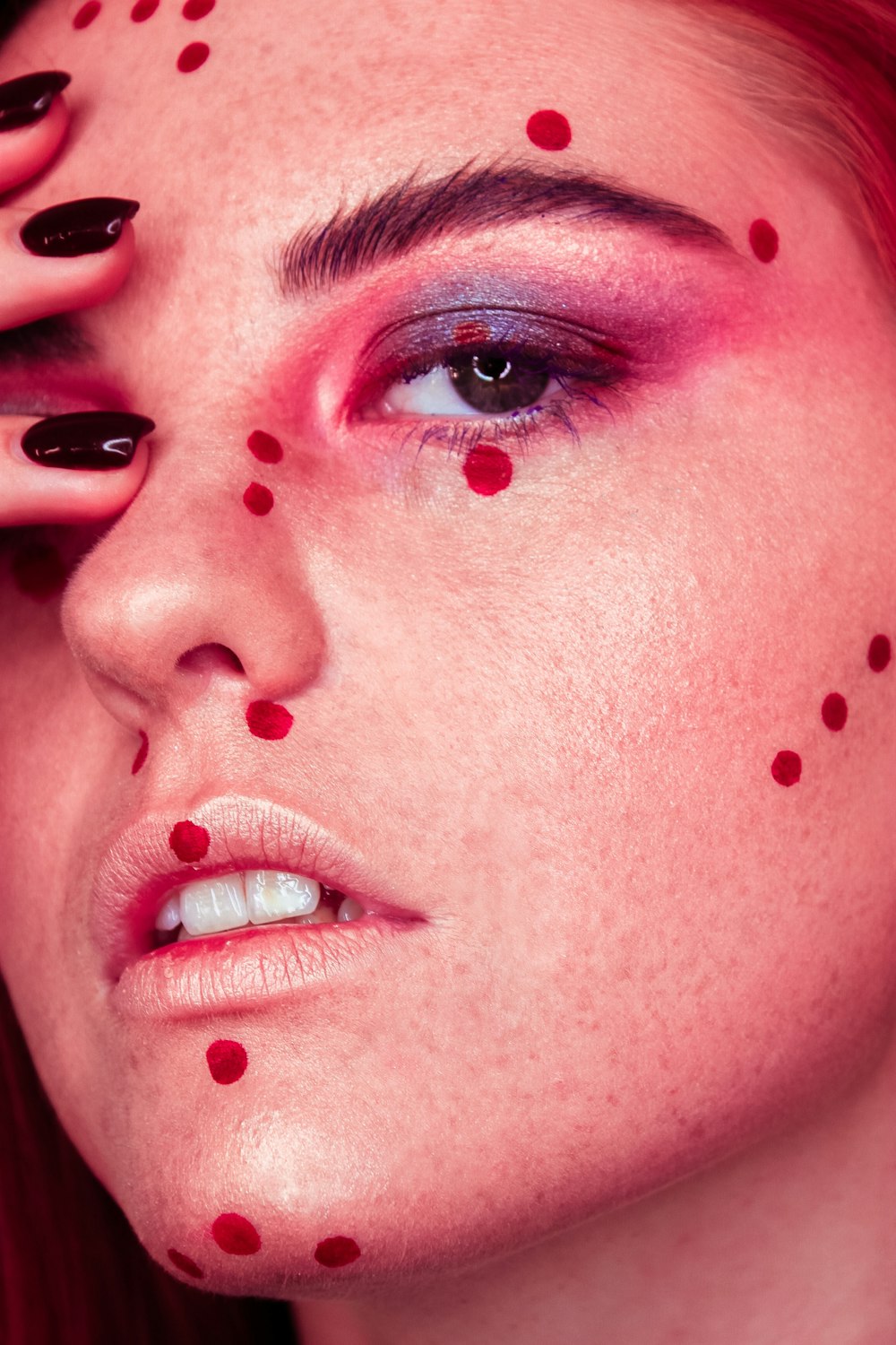woman's face with red dots