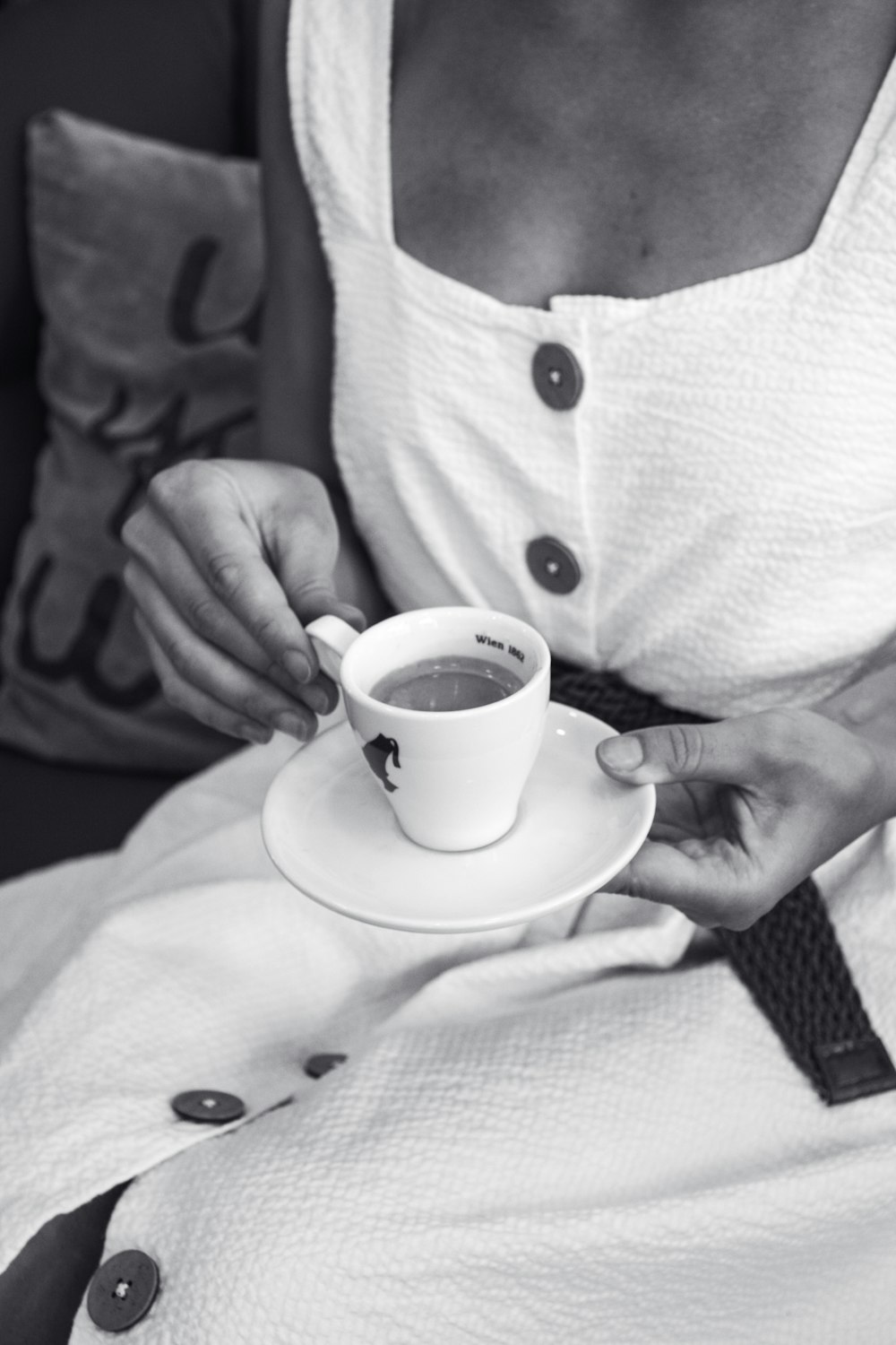 grayscale photography of woman holding mug