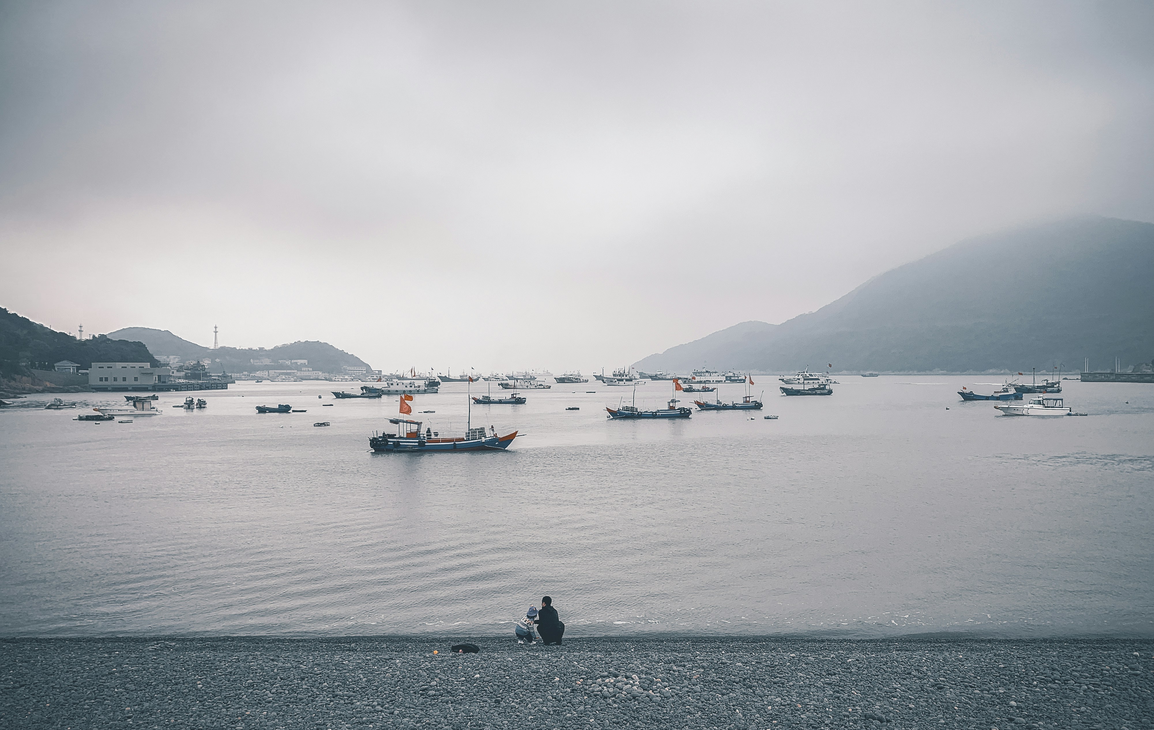 boats on body of water under cloudy sky