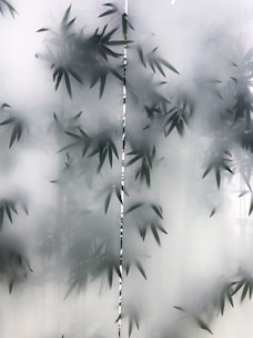Frosted glass panel with outlines of bamboo leaves visible, creating an abstract and tranquil appearance.