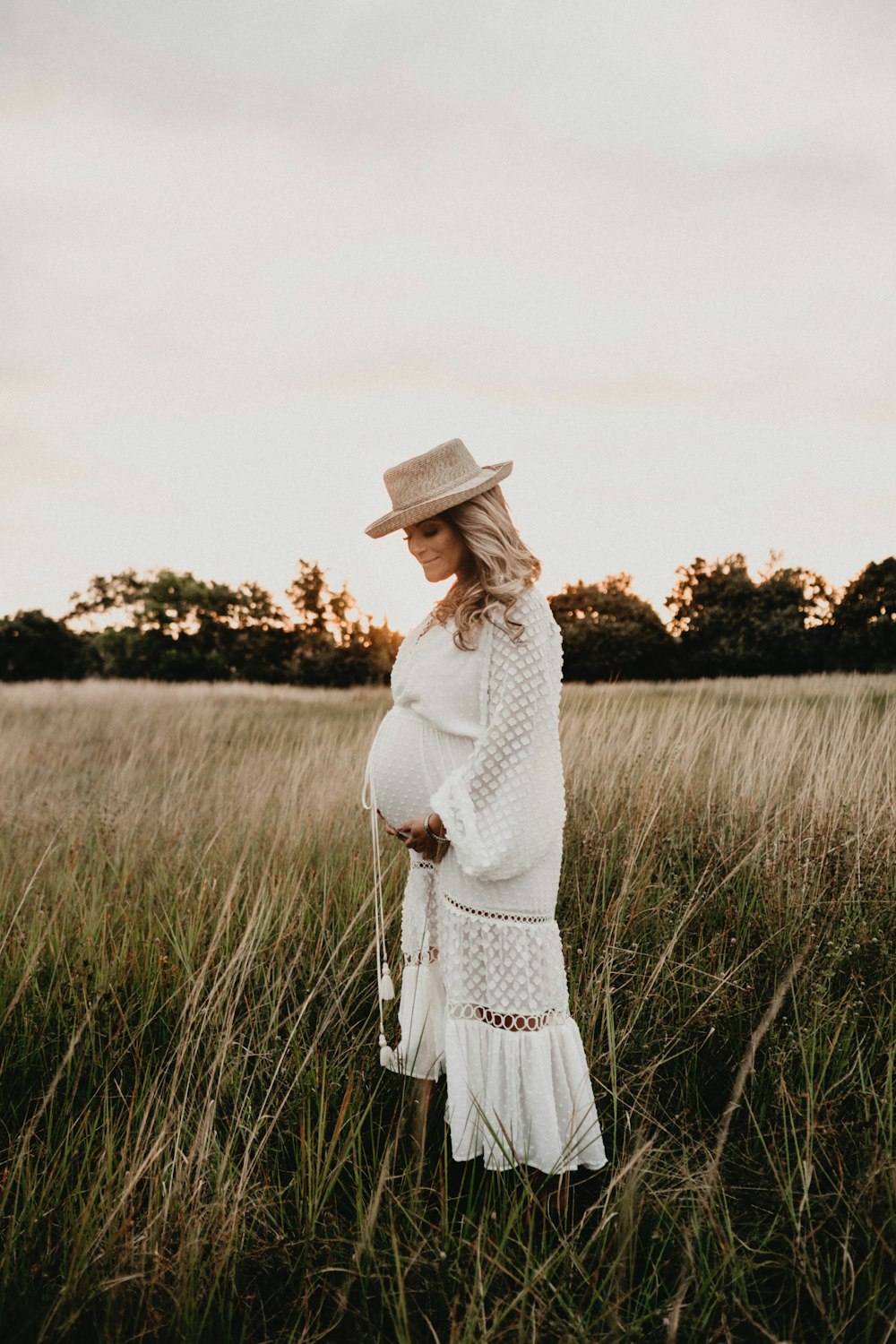 woman standing on green grass at daytime