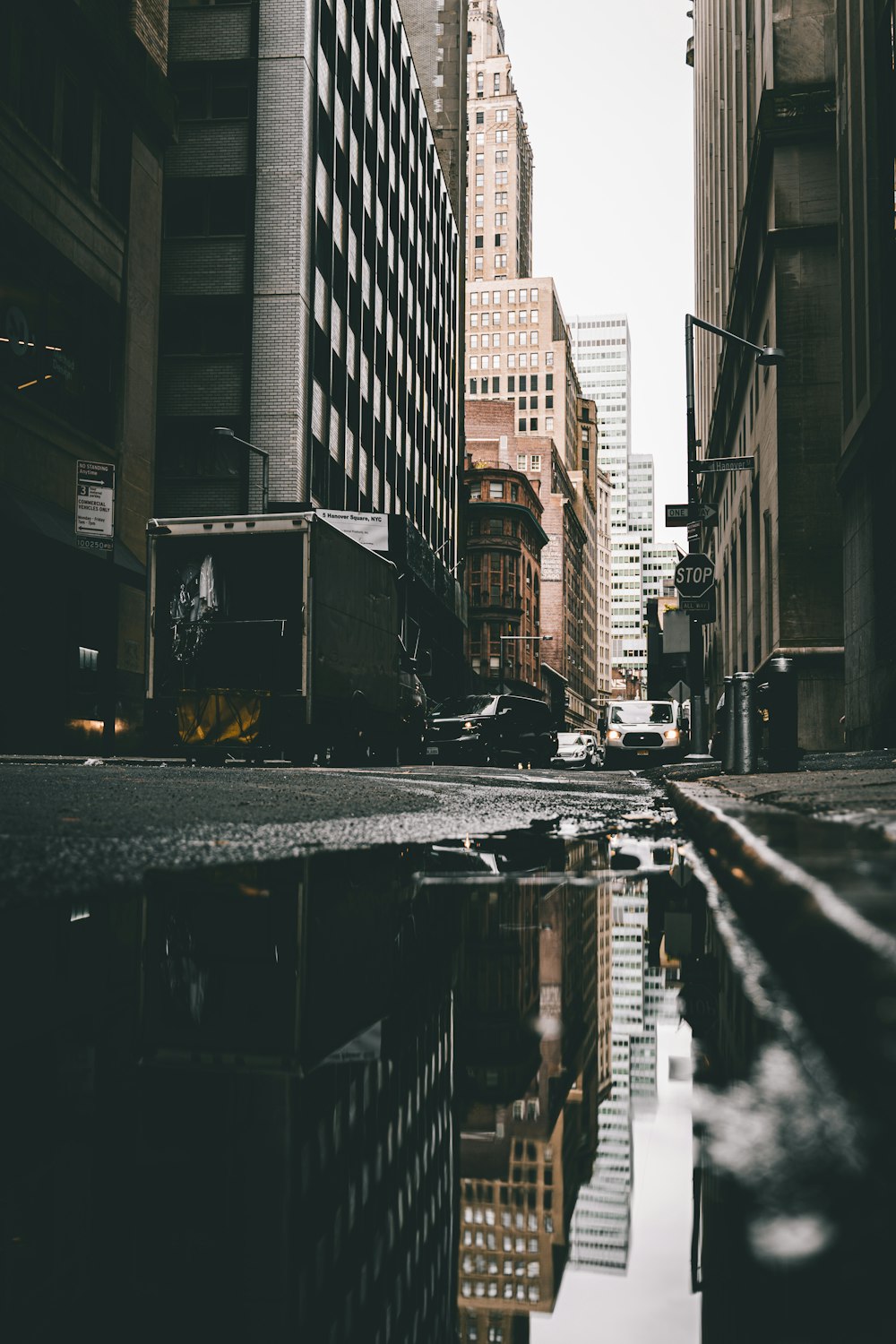 a city street with a puddle in the middle of it