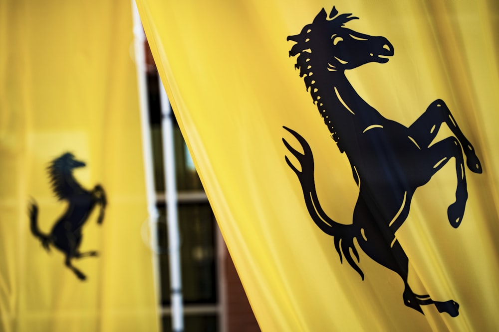 black horse logo printed on yellow curtain