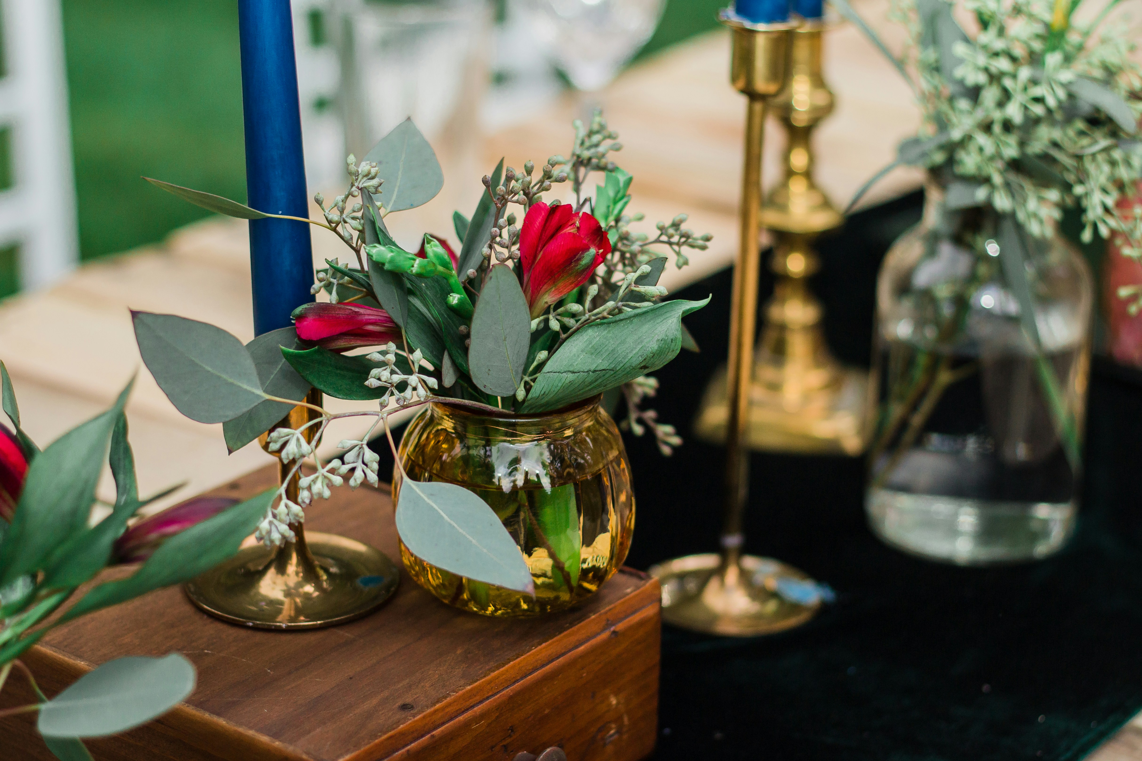 Red rose in a jar beside candles