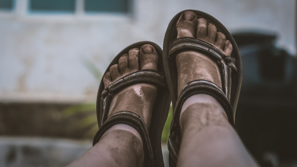 person wearing brown hiking sandals