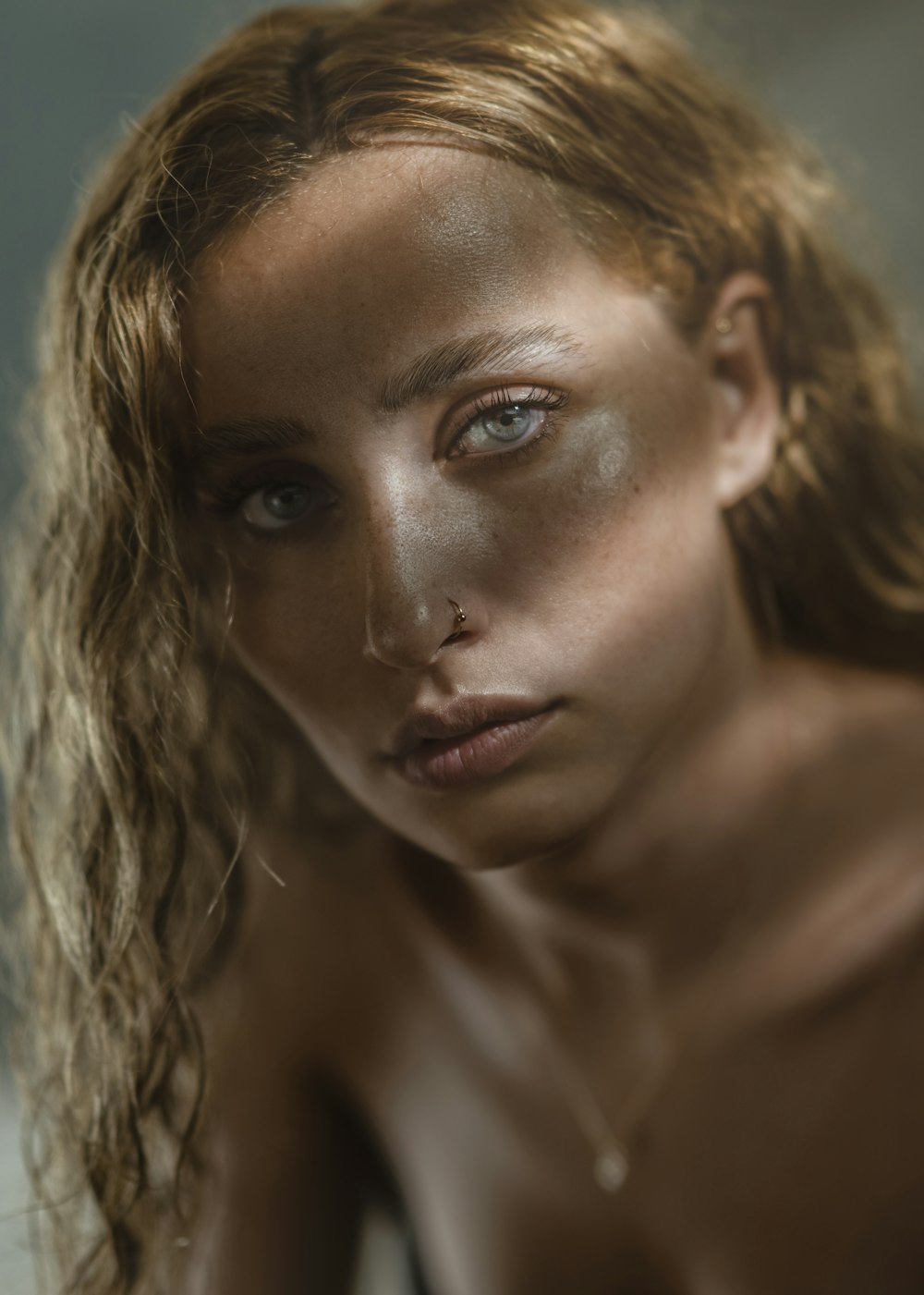 a naked woman with freckles on her face