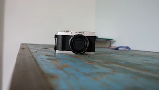 Vintage ophthalmoscope resting on a wooden table, its worn leather handle telling stories of decades of eye exams