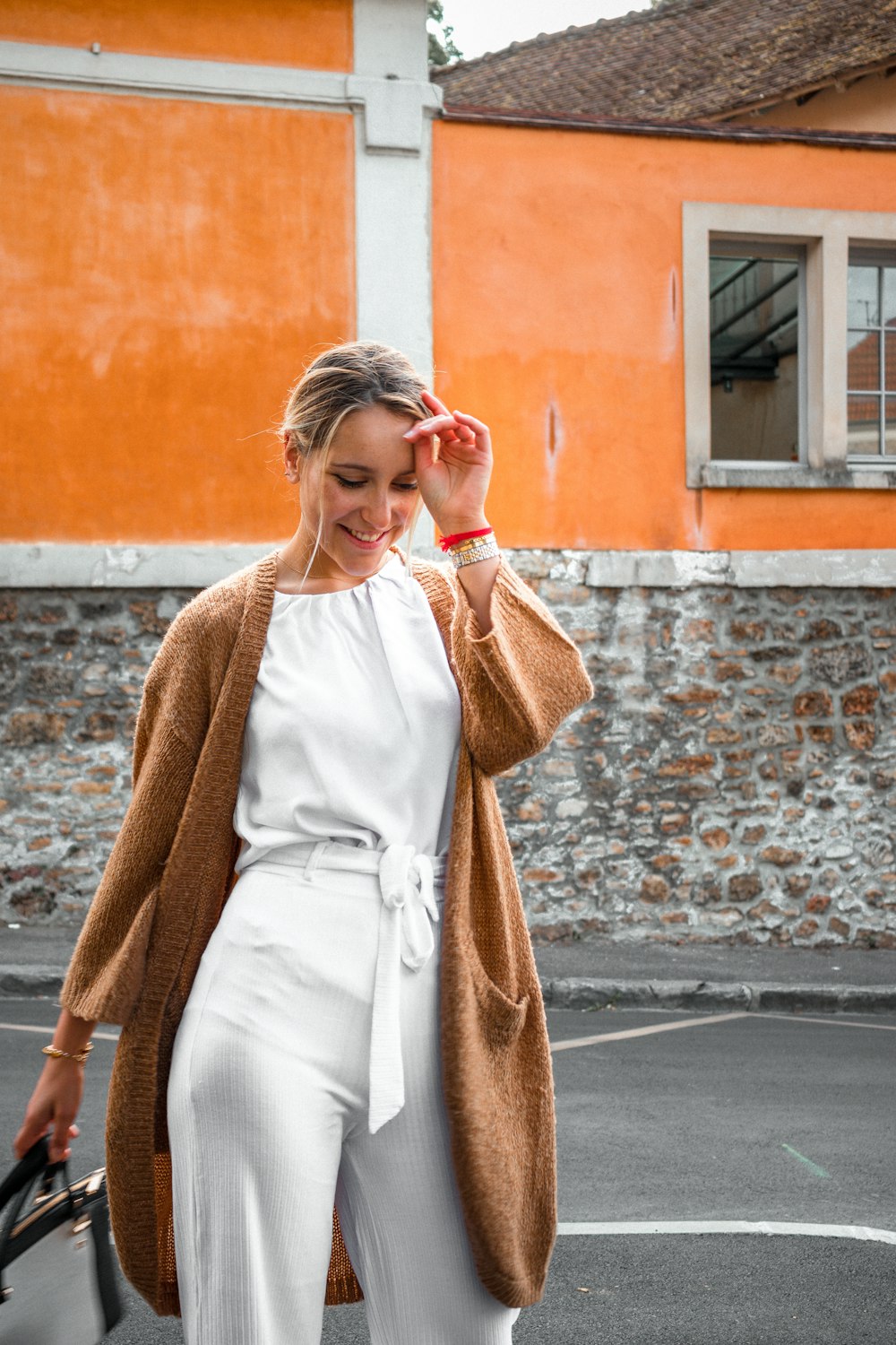 smiling woman standing near building