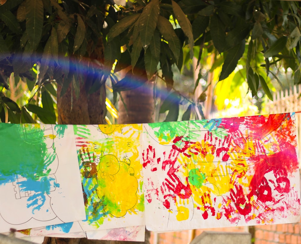 a group of children's handprints hanging from a clothes line