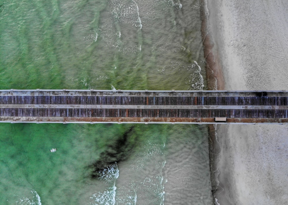 an aerial view of a bridge over a body of water