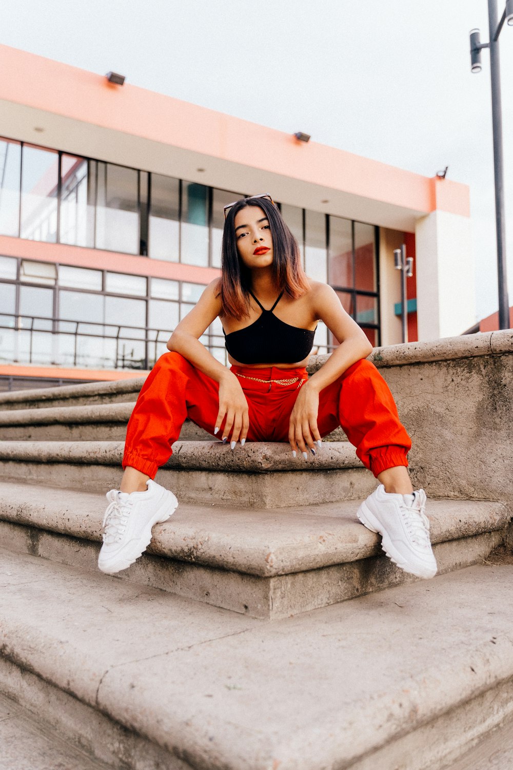 woman sitting on concrete stairs