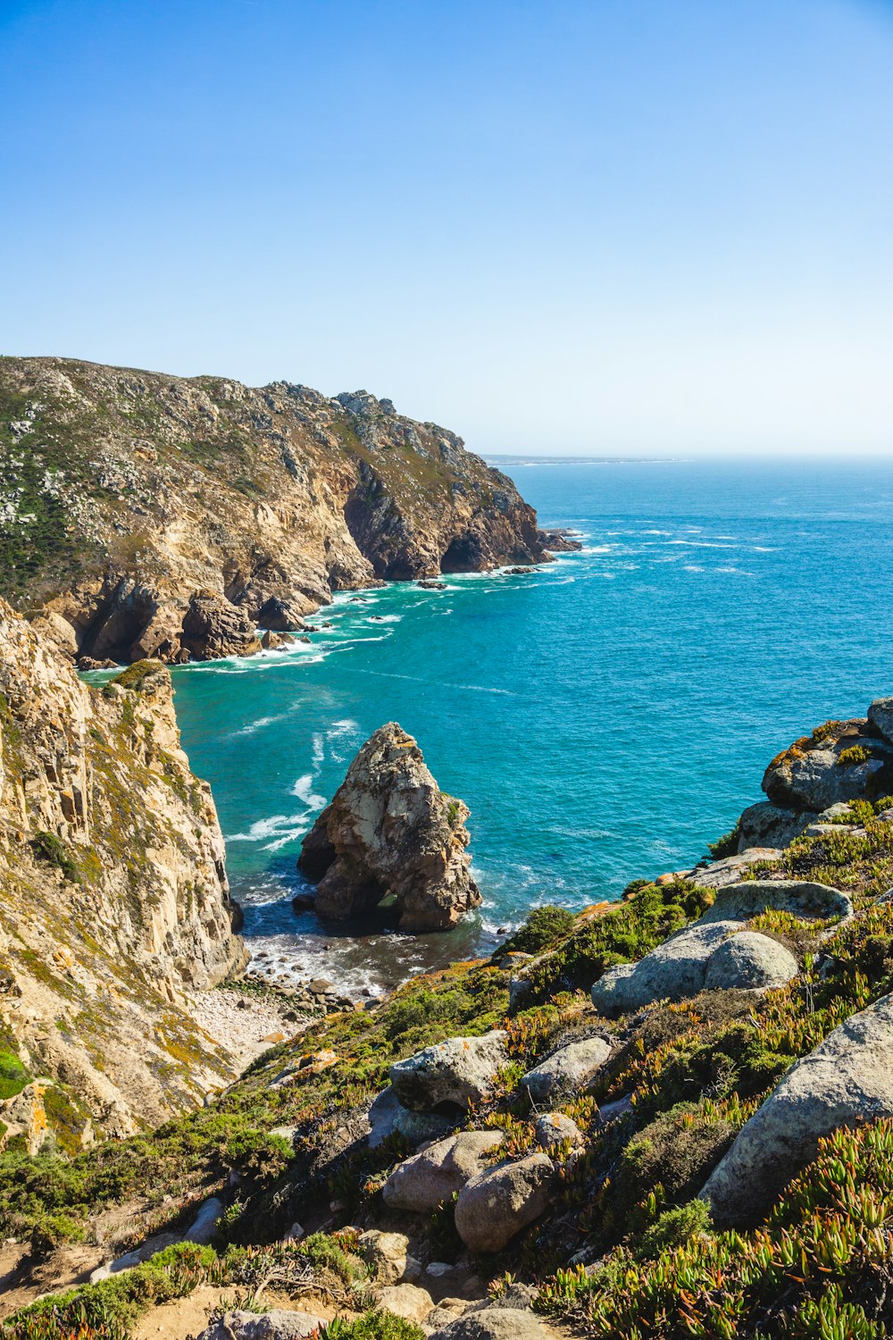 a view of the ocean from the top of a hill