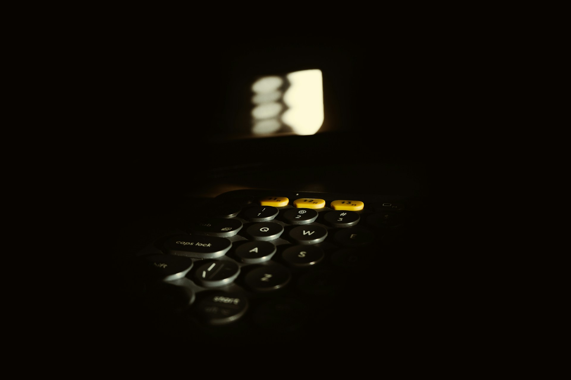 a close up of a calculator in the dark