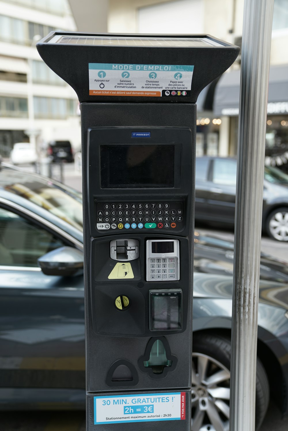 black coin operated telephone near post