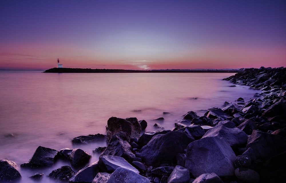 landscape photography of rocky seashore during golden hour