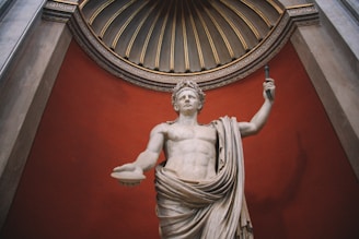 a statue of a man holding a staff