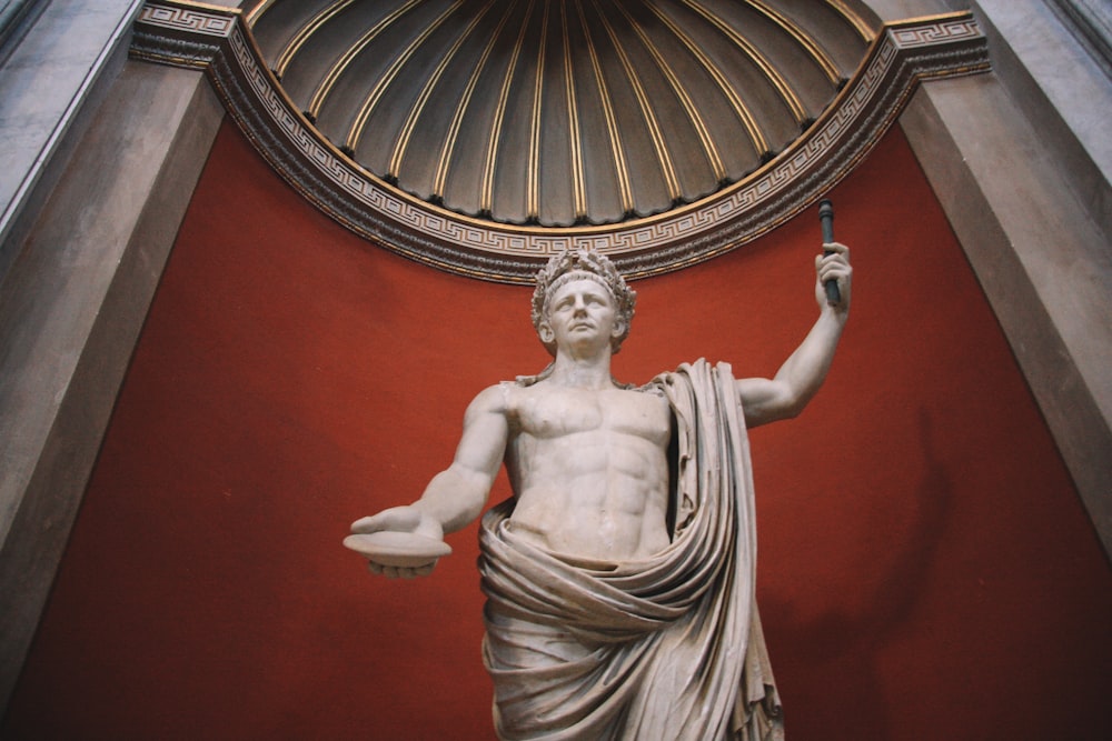 a statue of a man holding a staff