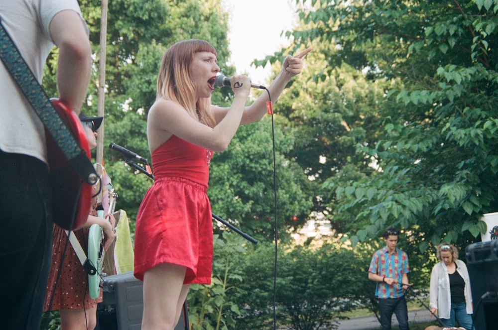 woman holding black microphone