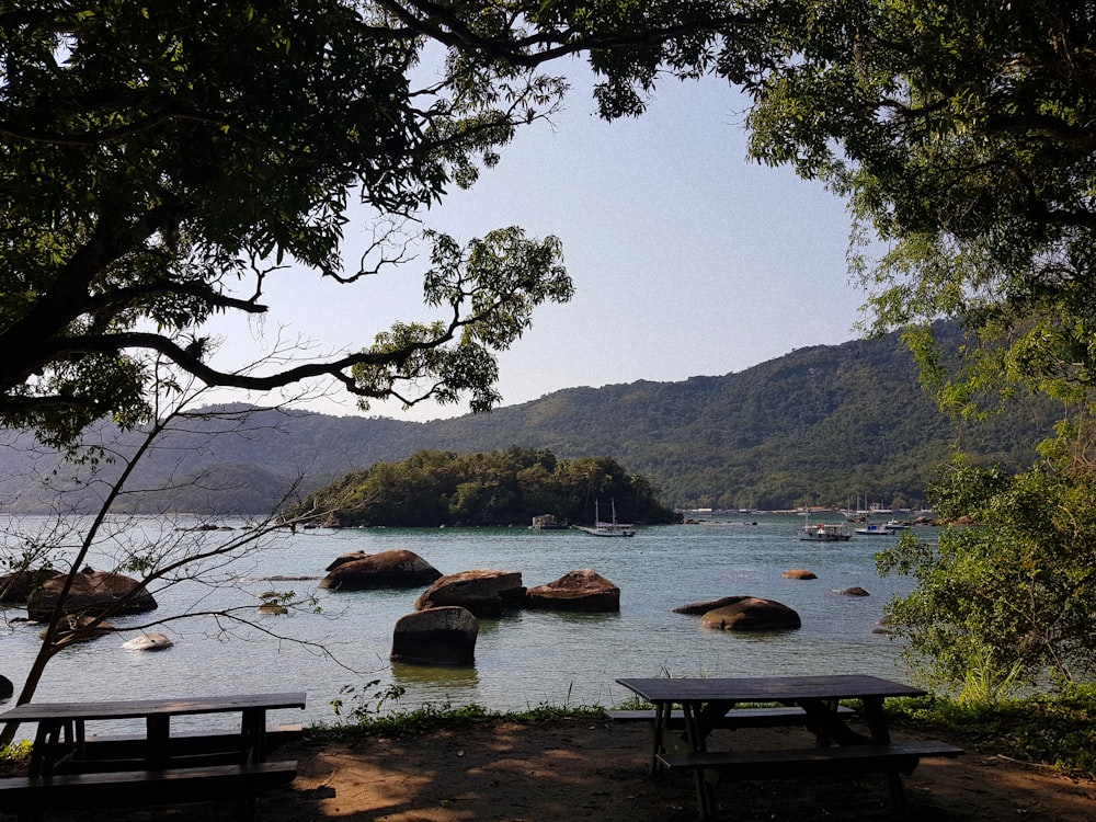 body of water near mountains at daytime