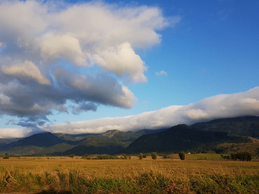 green and black mountains under blue and white sky at daytime