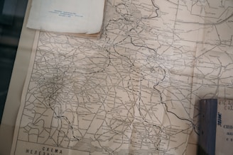 A vintage map shows detailed railways and regional locations around Moscow, with text in Russian. The paper appears aged, with some visible wear along the edges.