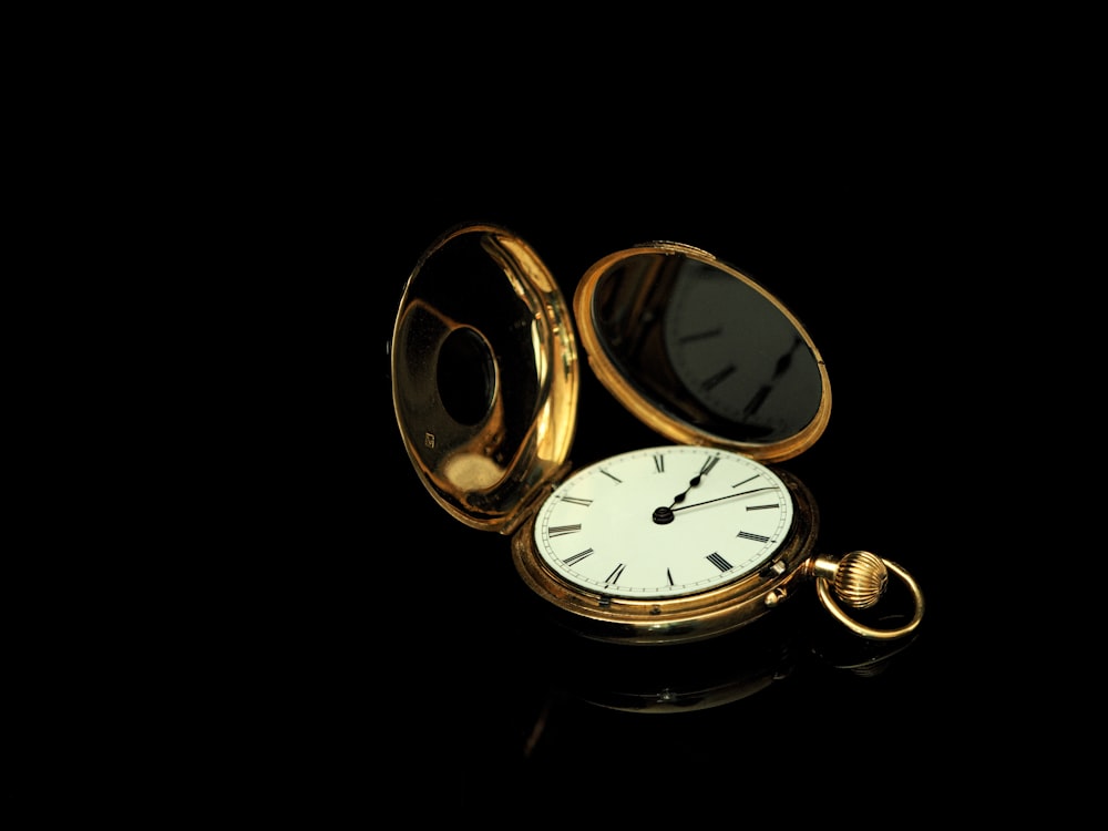 round gold pocket watch
