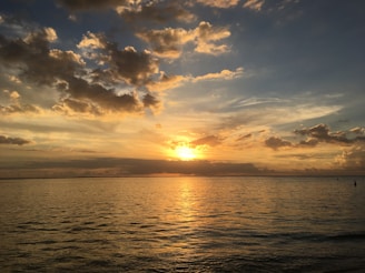 A stunning aerial view of a vibrant sunset over the ocean.