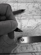 Close-up of hands planning routes on a map with transport icons