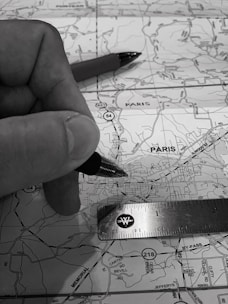A close-up of hands working on a map with markers and notes symbolizing strategic planning.