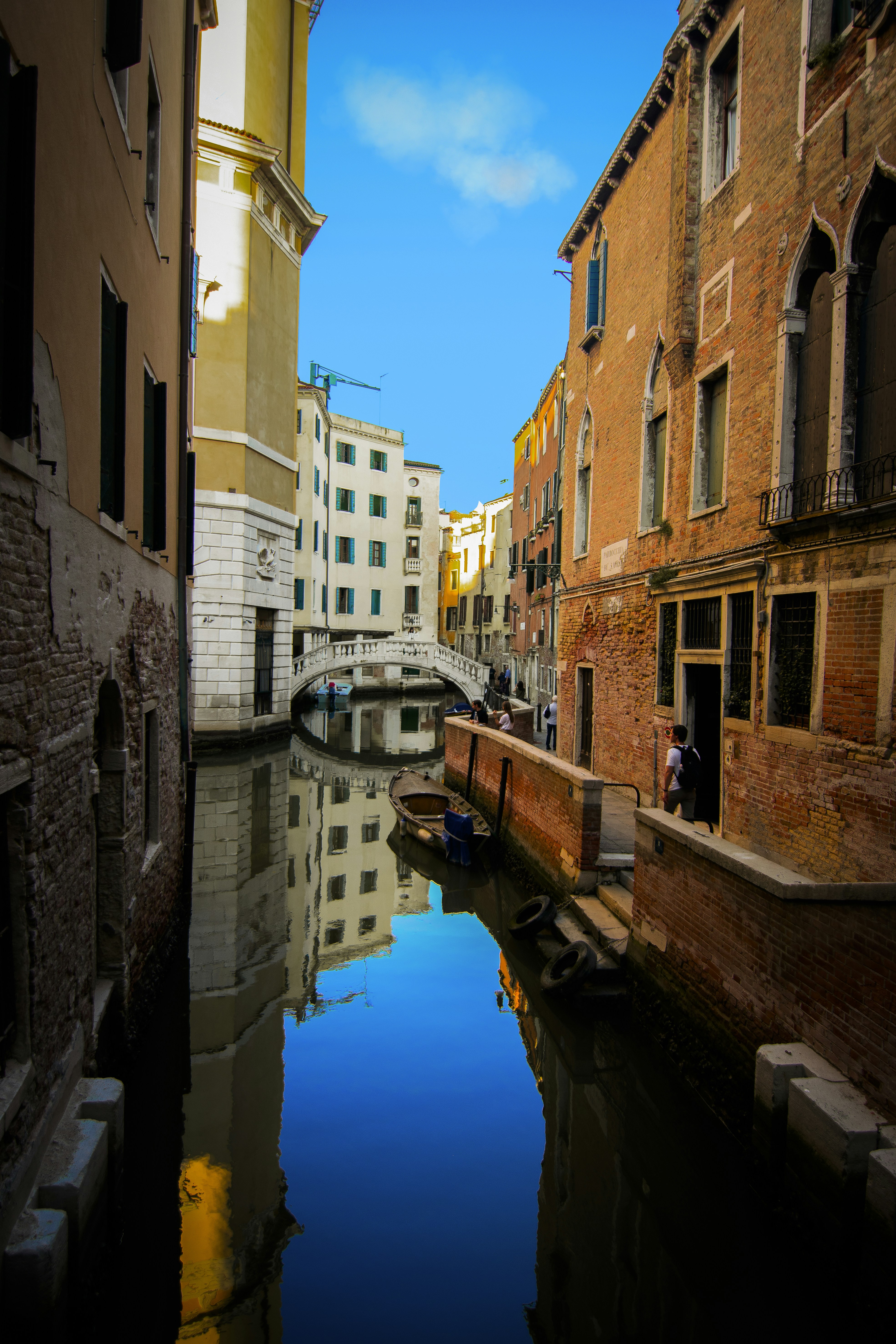 canal between brick buildings