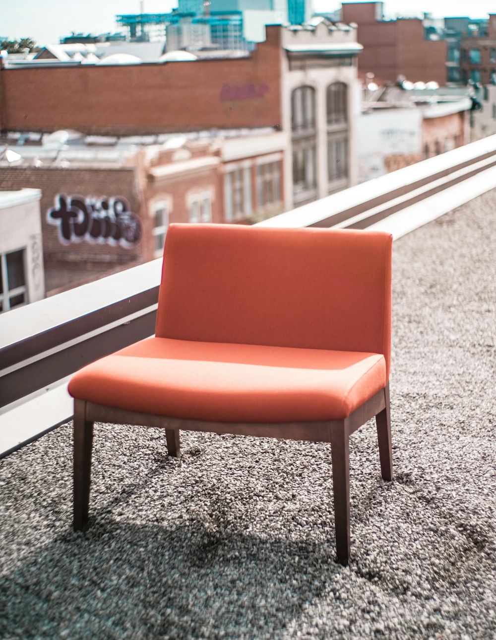 brown and orange wooden padded chair