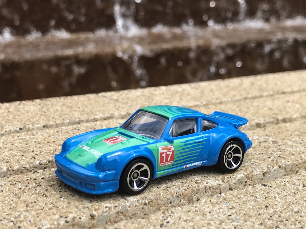 selective focus photography of blue and green 17 race car toy
