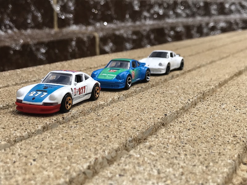 A curated row of Hot Wheels Porsches staged with breathing room — exactly the kind of display setup that turns a collection into a showpiece