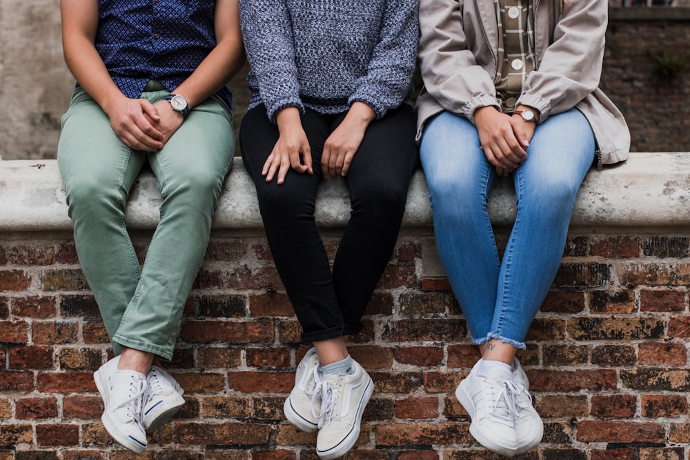 three person sitting on focus photography