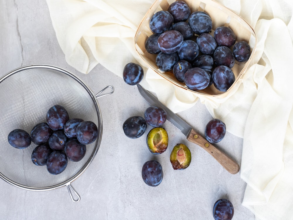 blueberries in glass containers and on white surface