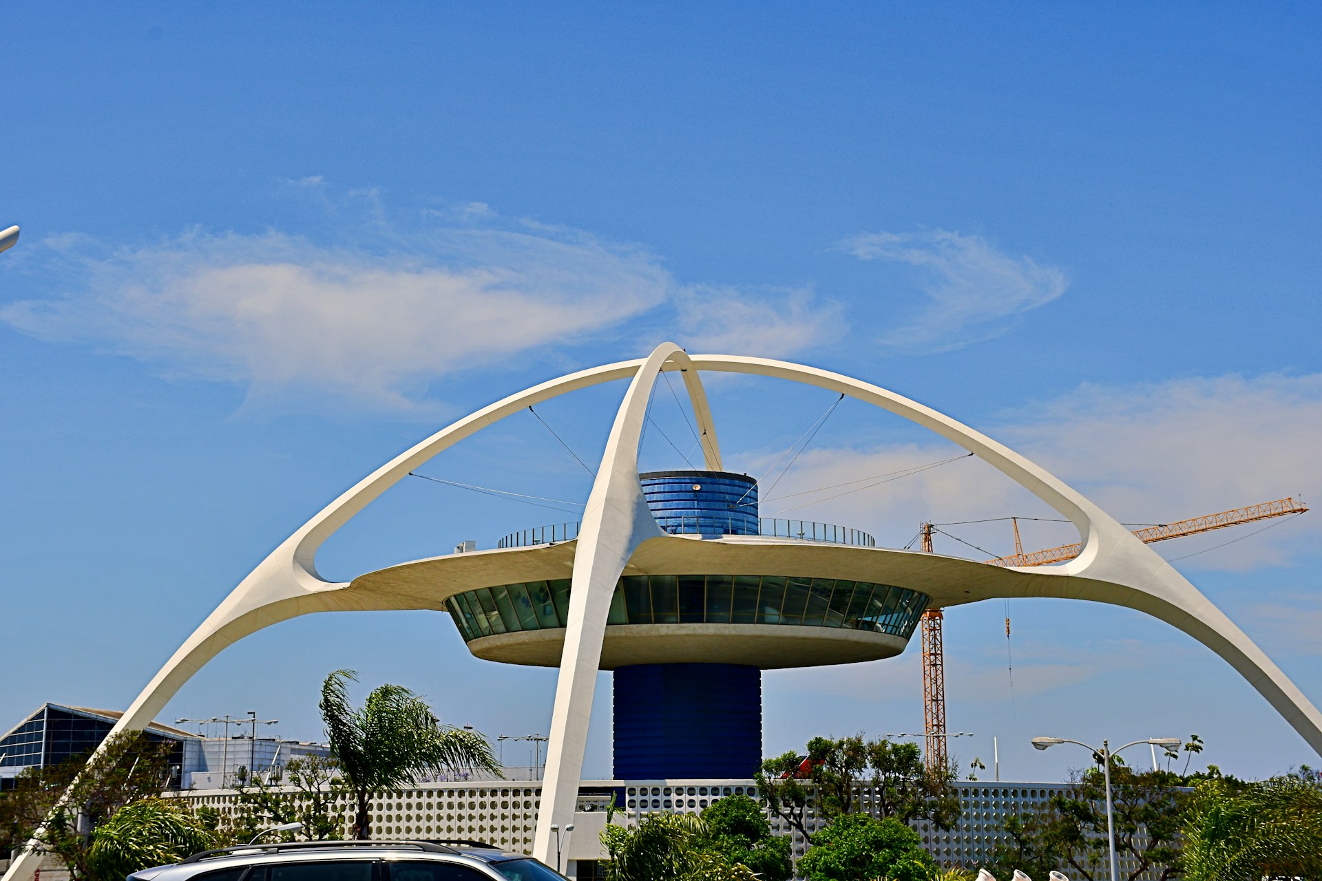woman wearing yellow long-sleeved dress under white clouds and blue sky during daytime