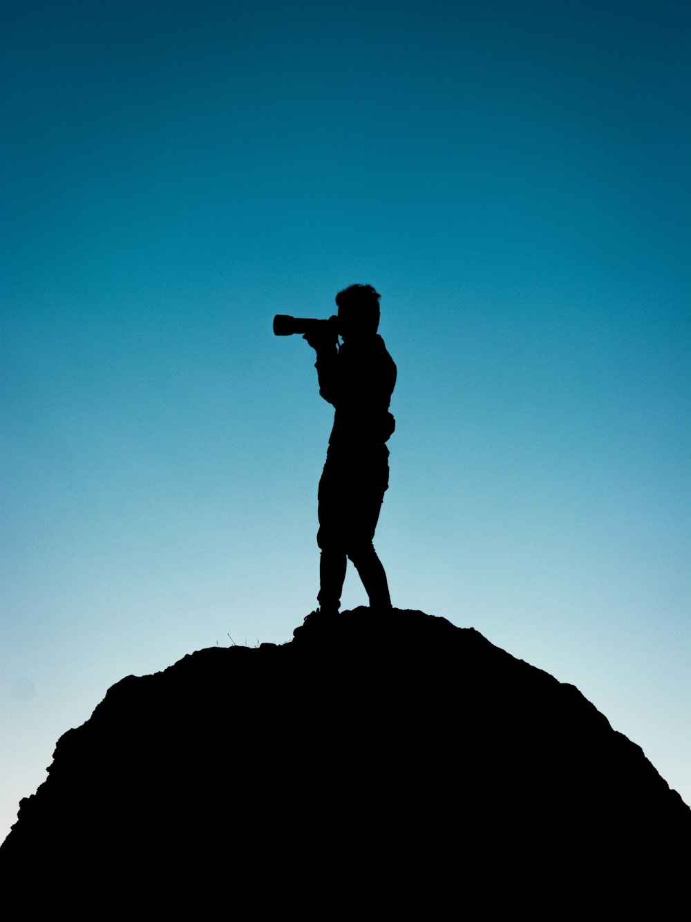 silhouette of person holding telescope graphic