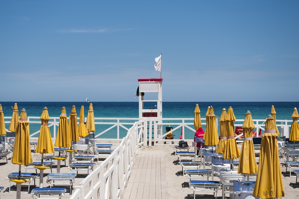 yellow beach umbrellas viewing blue sea during daytime