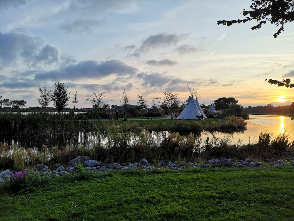 tipi tent facing body of water