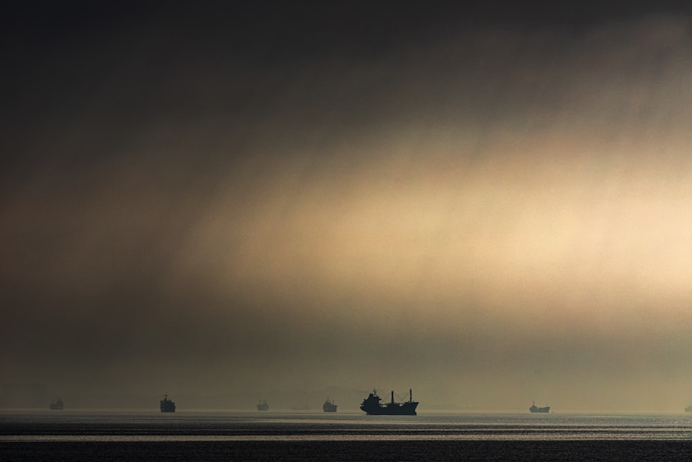 a group of ships floating on top of a large body of water