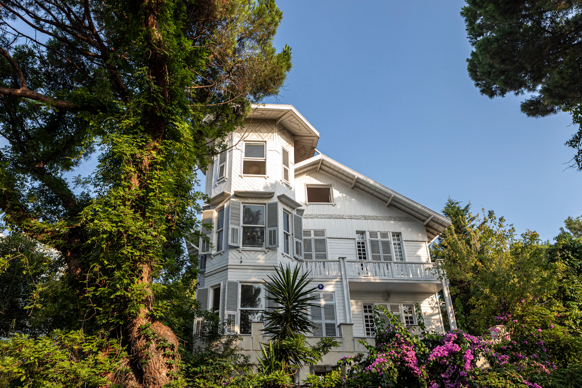 Surrounded by beautiful flowers and trees, the Turkish villa stands out.