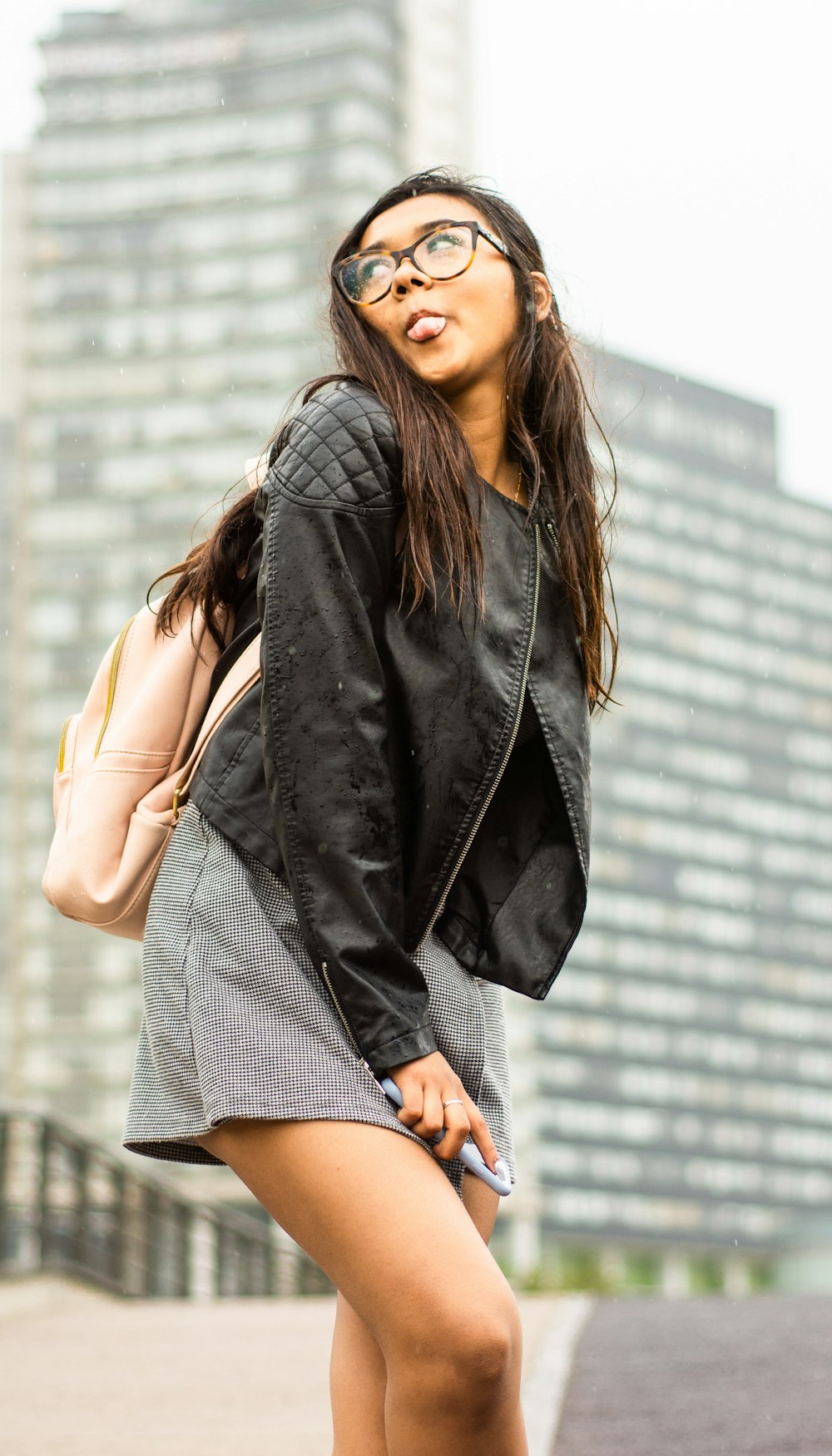 woman wears black leather zip-up jacket