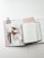An open planner is laid out on a table, featuring a page with the text 'You got this'. Beside it, there is a notebook with a magazine partially visible, showing a person in a white garment. Two pens are placed on top of the magazine, and a binder clip is attached to the notebook.