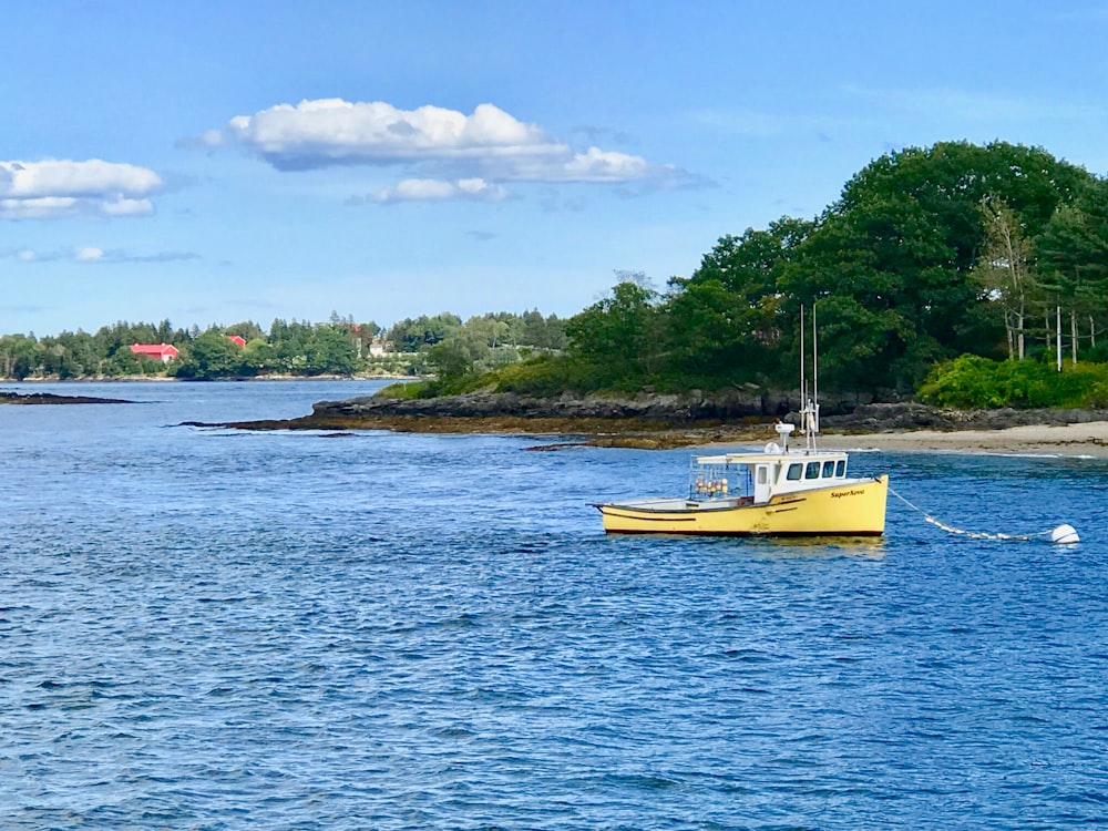 yellow and white boat on sea