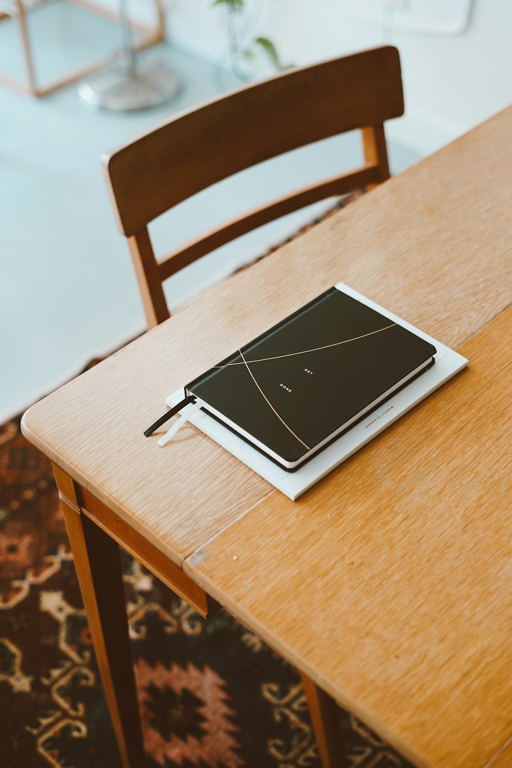 black planner on wooden table