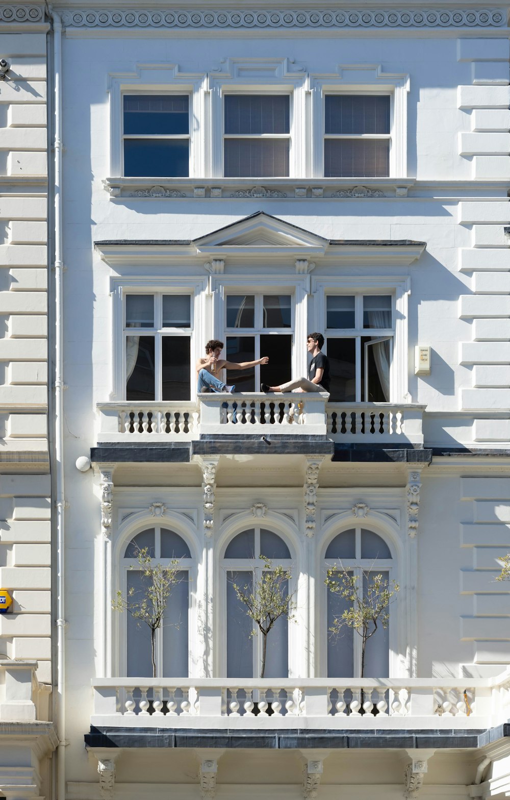 two men on terrace of white house